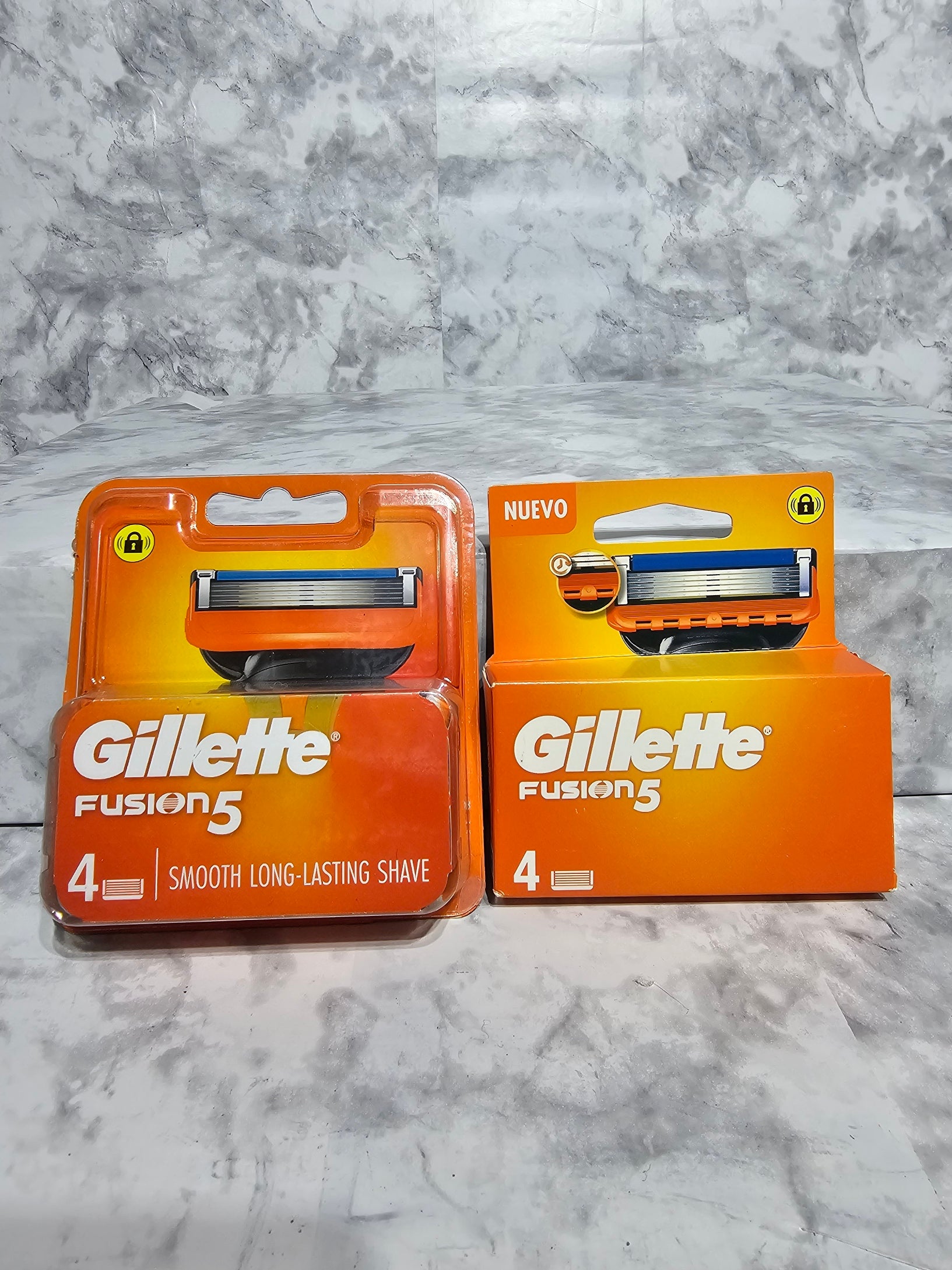 Two packages of Gillette Fusion5 razors on a gray marble surface