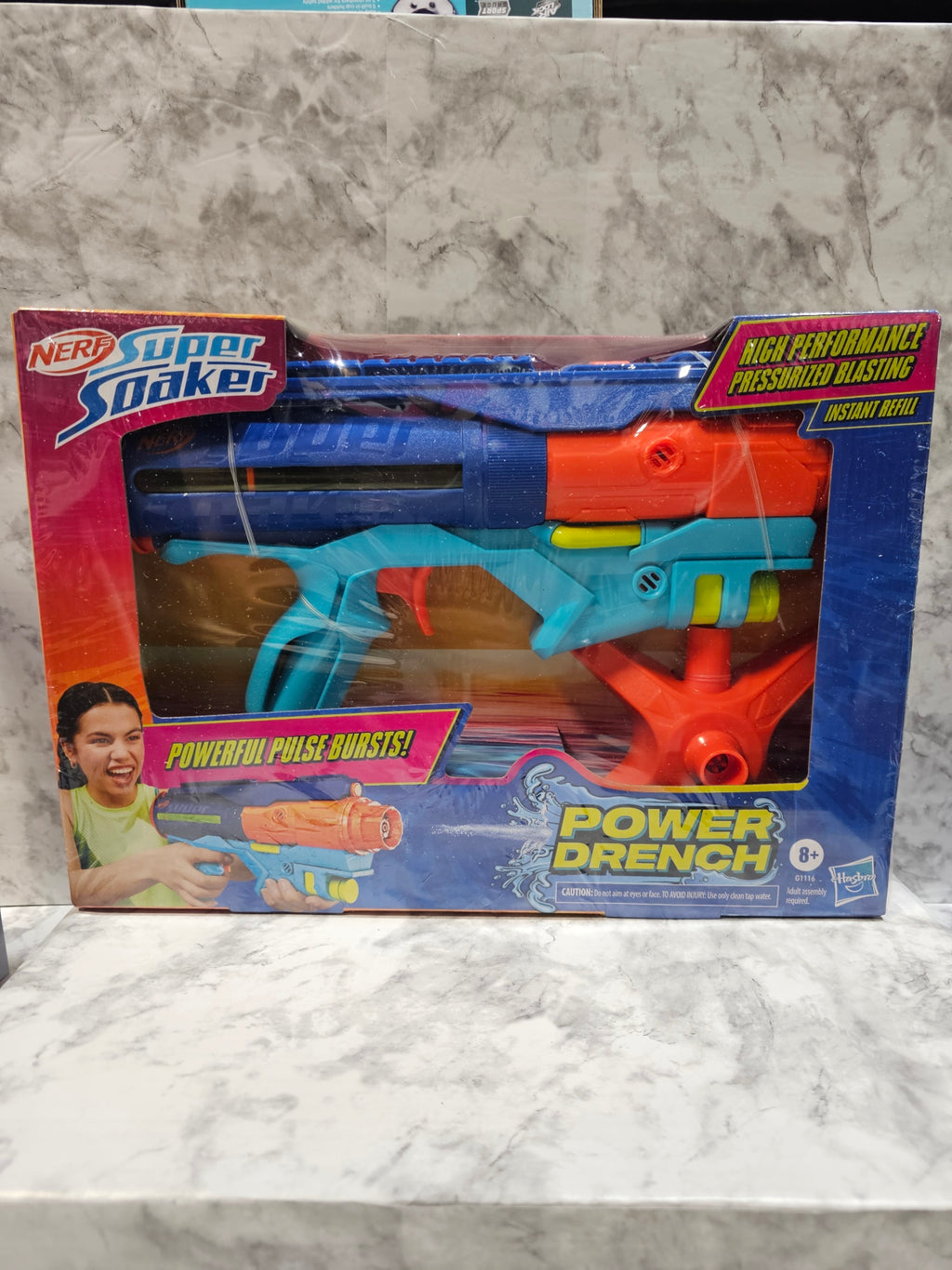 Toy power wrench set in its packaging on a marble surface