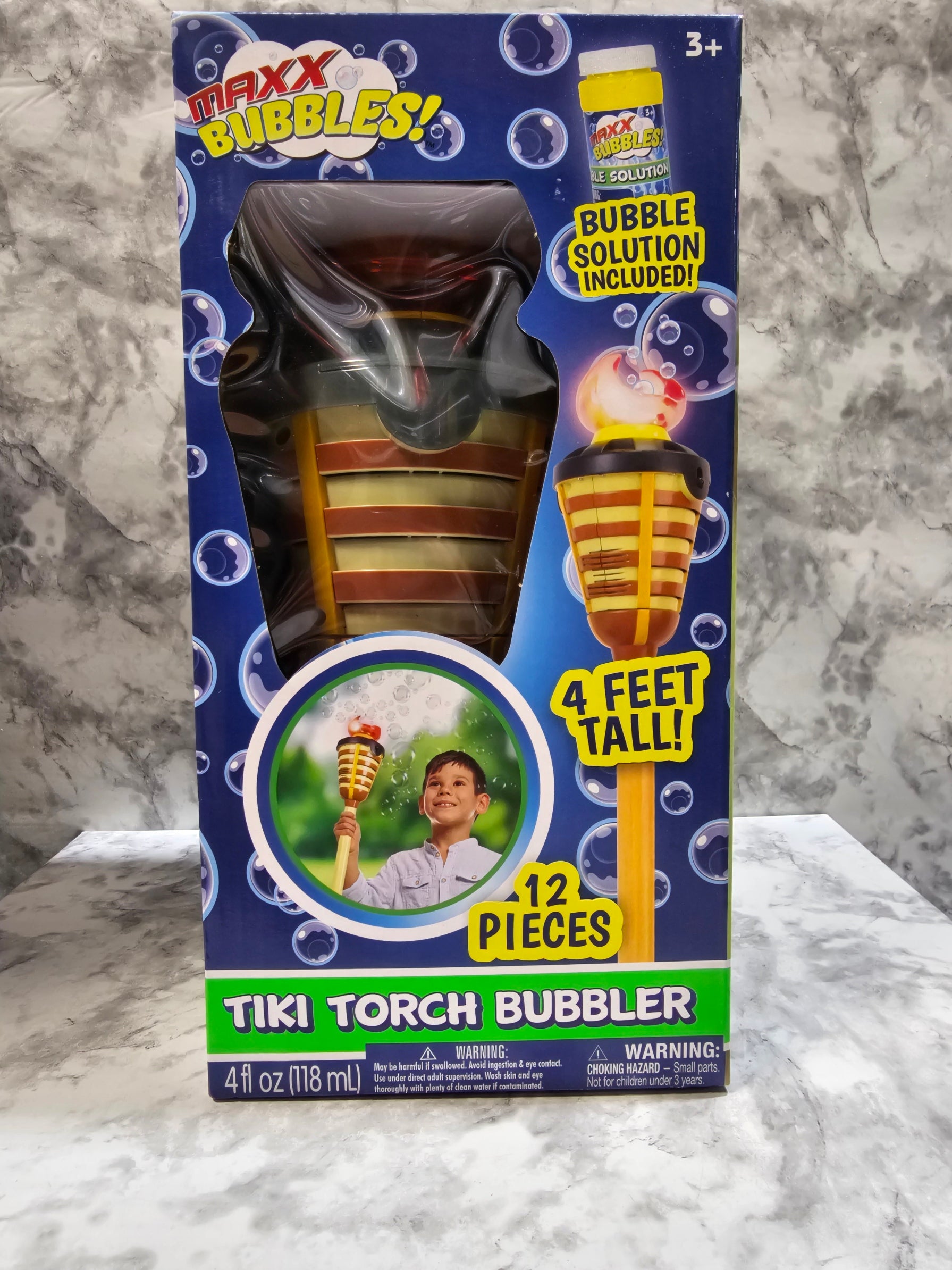 Tiki torch bubbler toy packaging on a marble surface