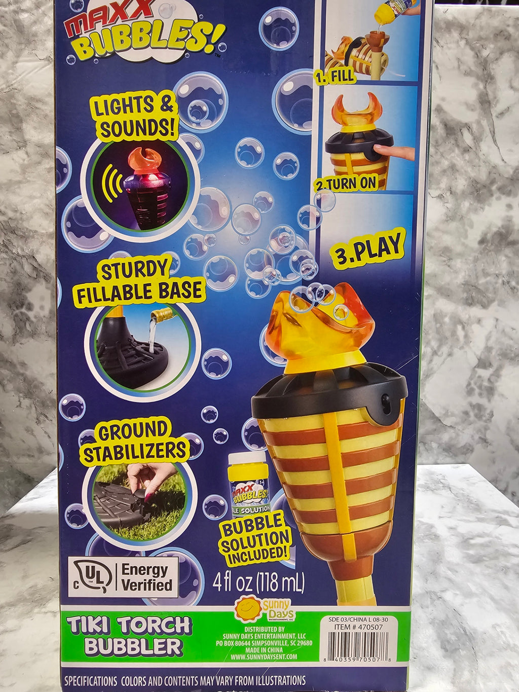 Maxx Bubbles tiki torch bubble machine packaging on a marble surface