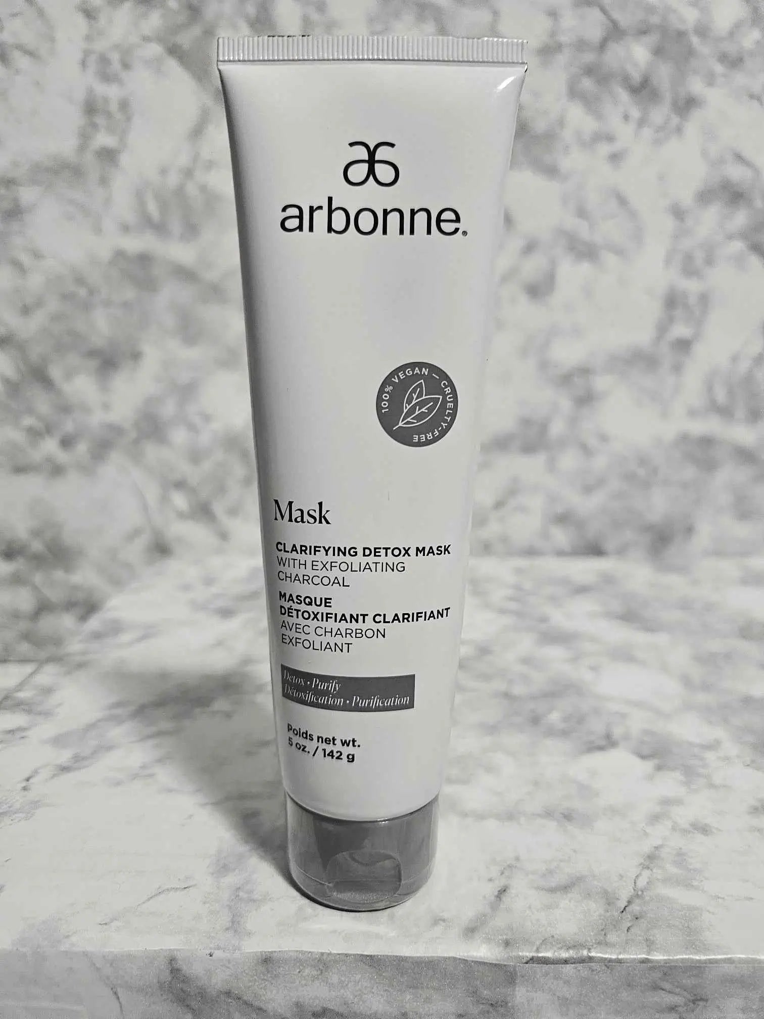 Arbonne Clarifying Detox Mask with Exfoliating Charcoal 5 oz tube on marble surface - More4less Outlet
