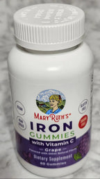 Supplement bottle labeled 'Iron' on a gray marble surface