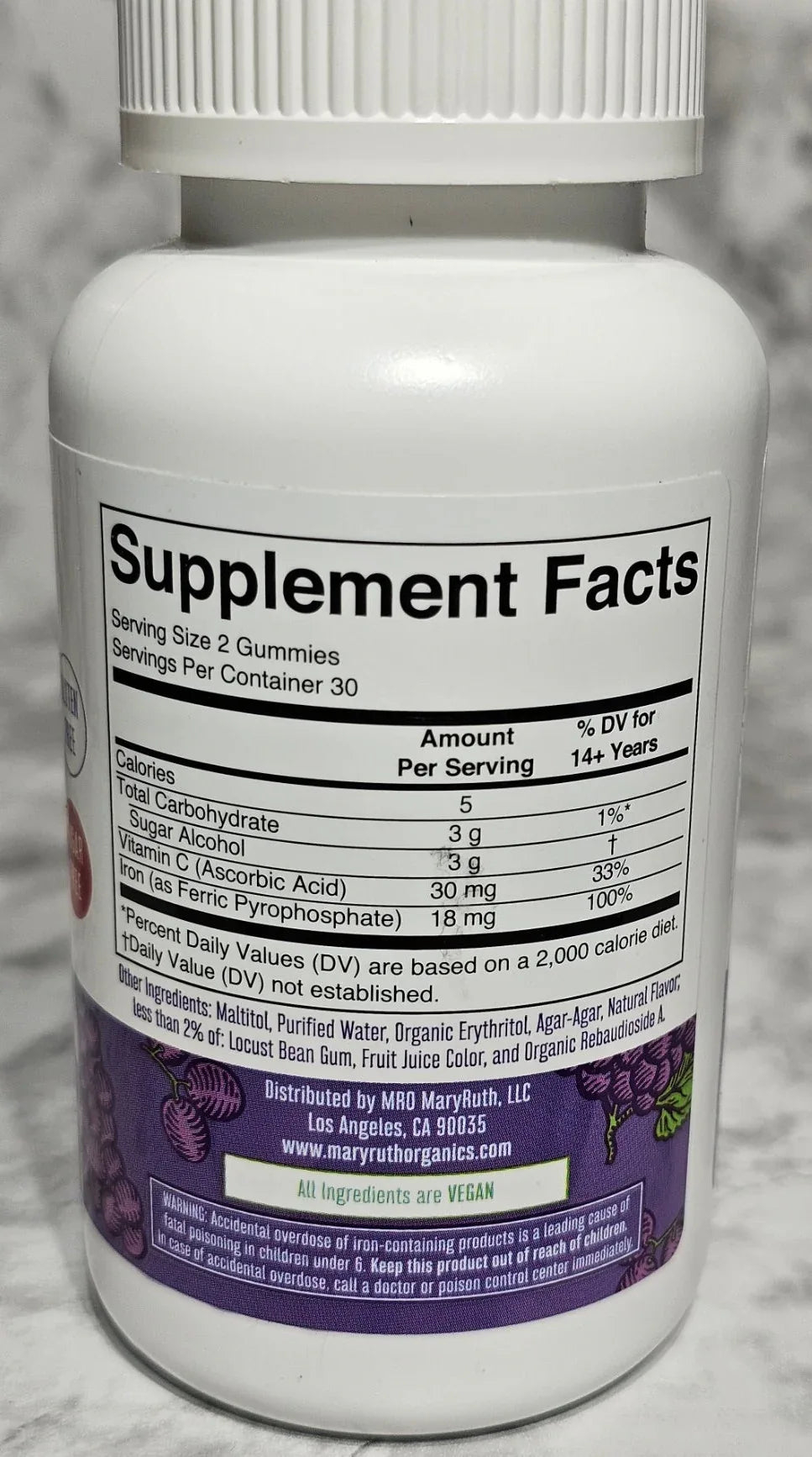 Supplement bottle with label on a textured surface