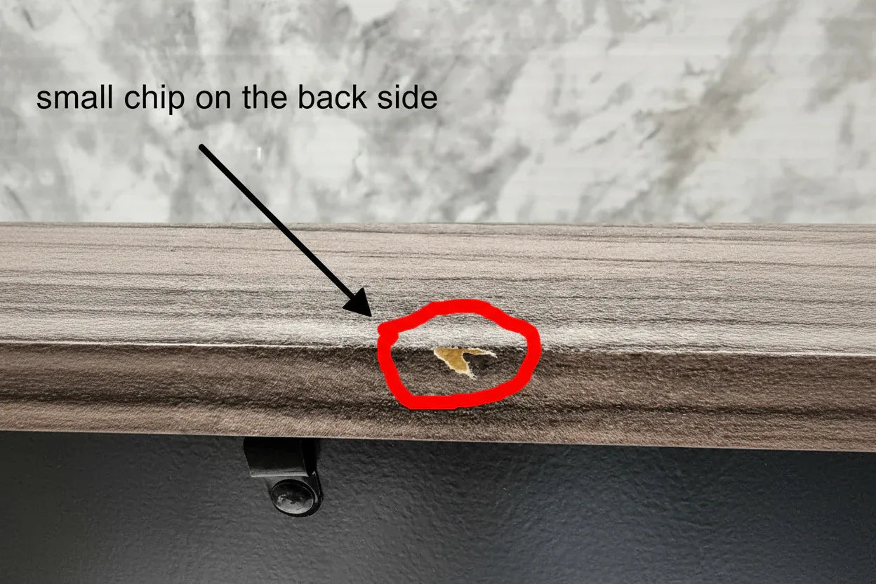 Close-up of a door with a small hole and a gold object inside, next to a marble surface.