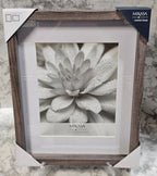 Mikasa picture frame with a flower photo inside on a textured surface