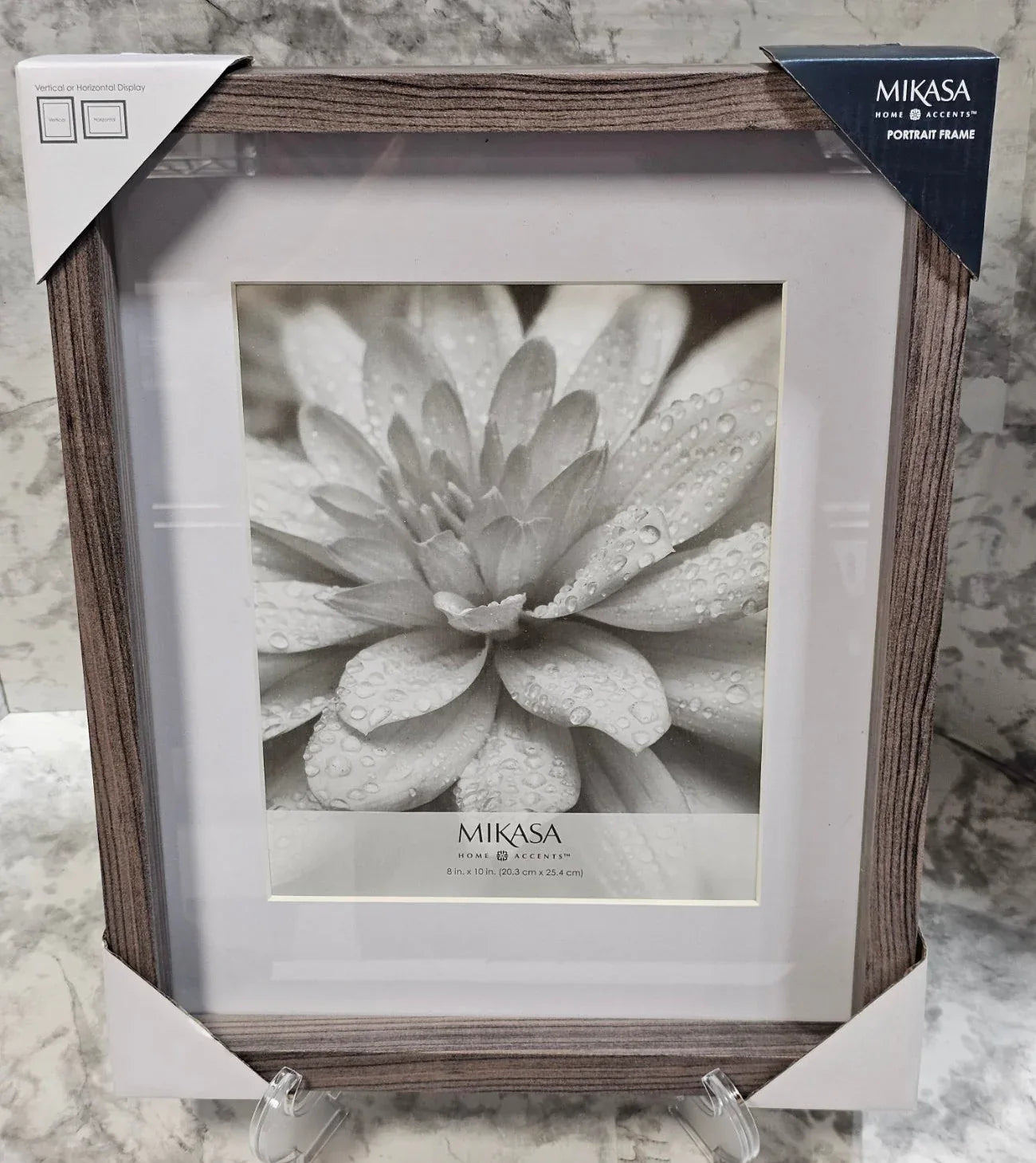 Mikasa picture frame with a flower photo inside on a textured surface