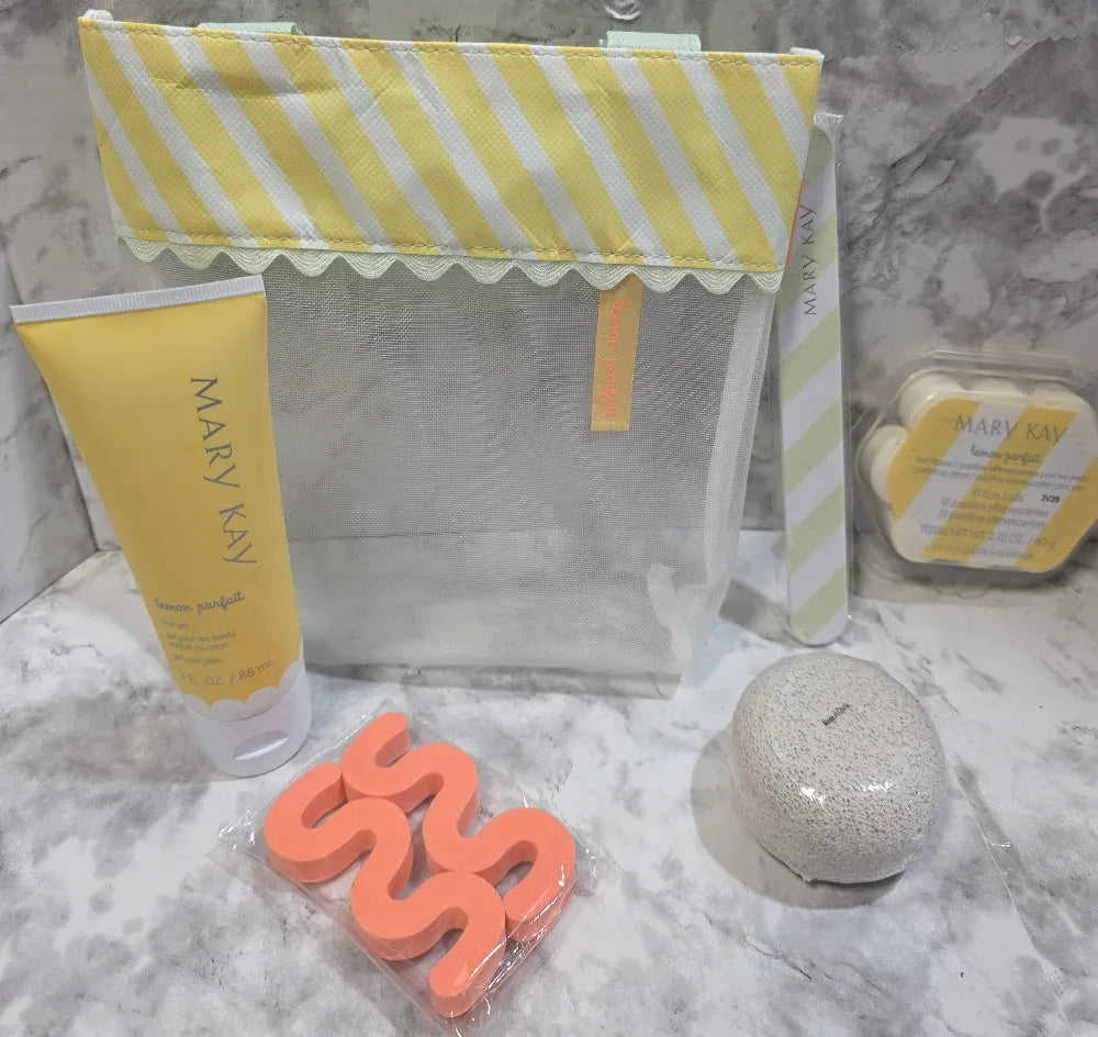 Mary Kay product on a marble surface with a yellow and white striped bag.