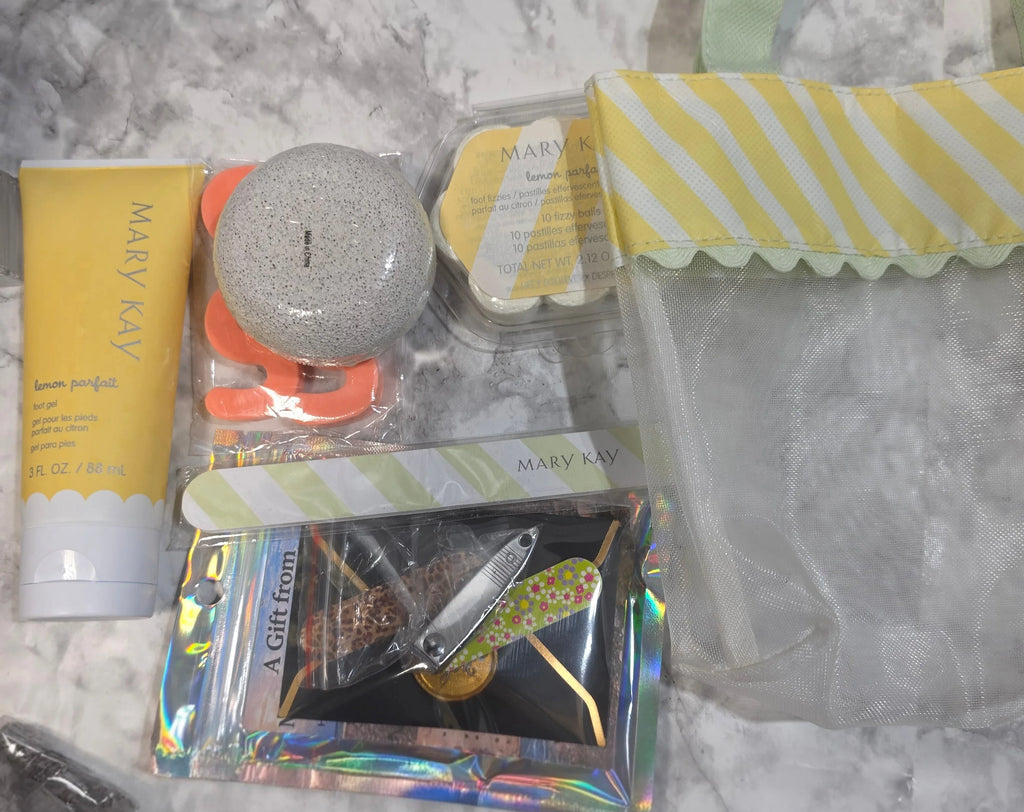 Assorted items including a tube of cream, a small bag, and a card on a marble surface.