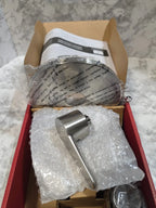 Metal door handle and lock set in packaging on a textured surface
