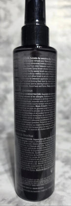 Black cylindrical object with text on a textured gray surface
