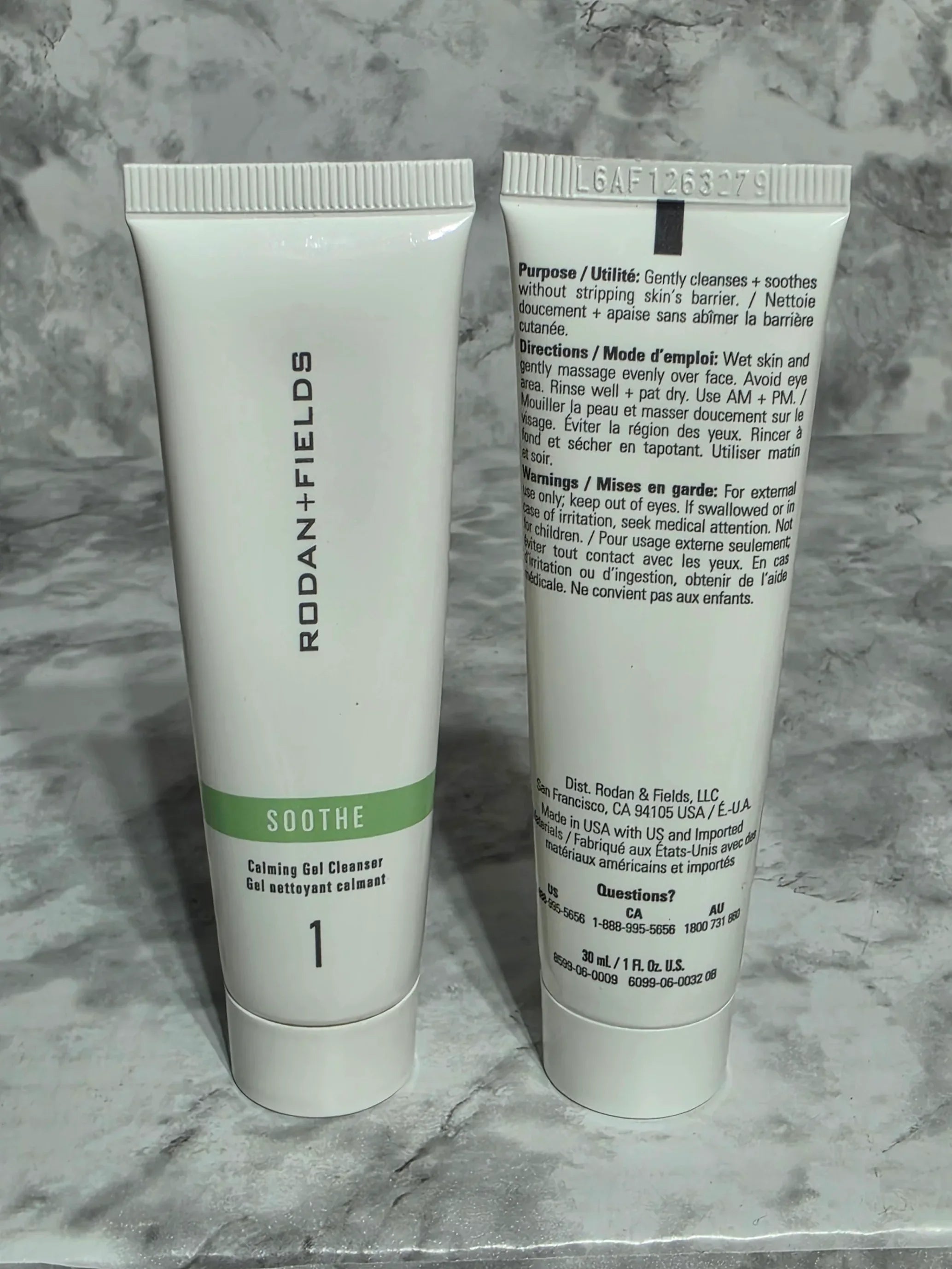 Two skincare products from Rodan + Fields on a marble surface