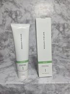 Rodan + Fields skincare product and packaging on a marble surface