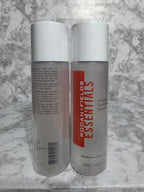 Two Rodan + Fields Essentials skincare bottles on a marble surface