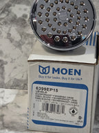 Chrome shower head with Moen packaging on a marble surface