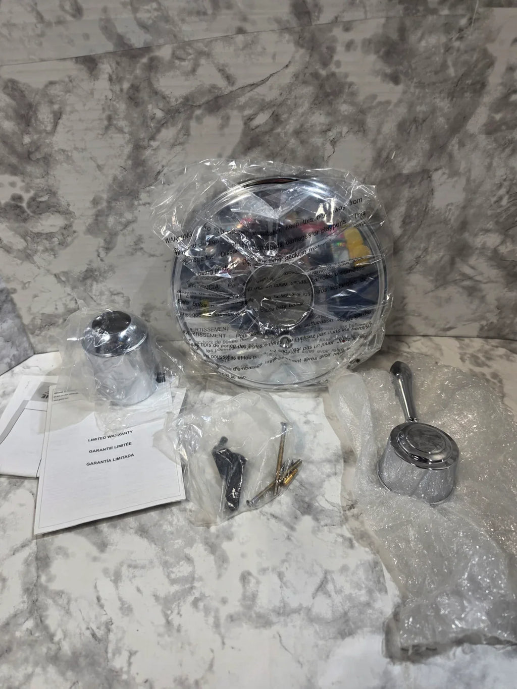 Car headlights and related parts on a marble surface