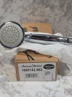 Chrome shower head with packaging on a marble surface