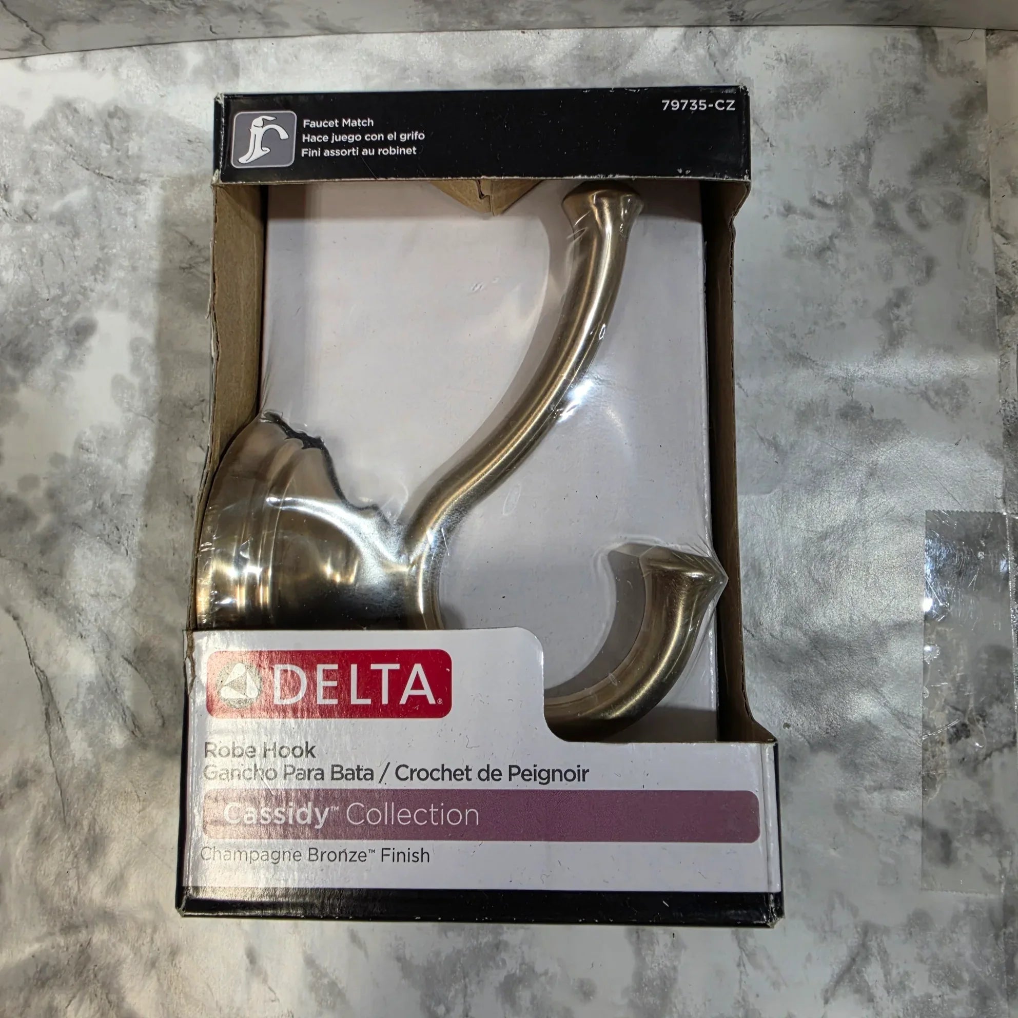 Decorative hook in packaging on a marble surface