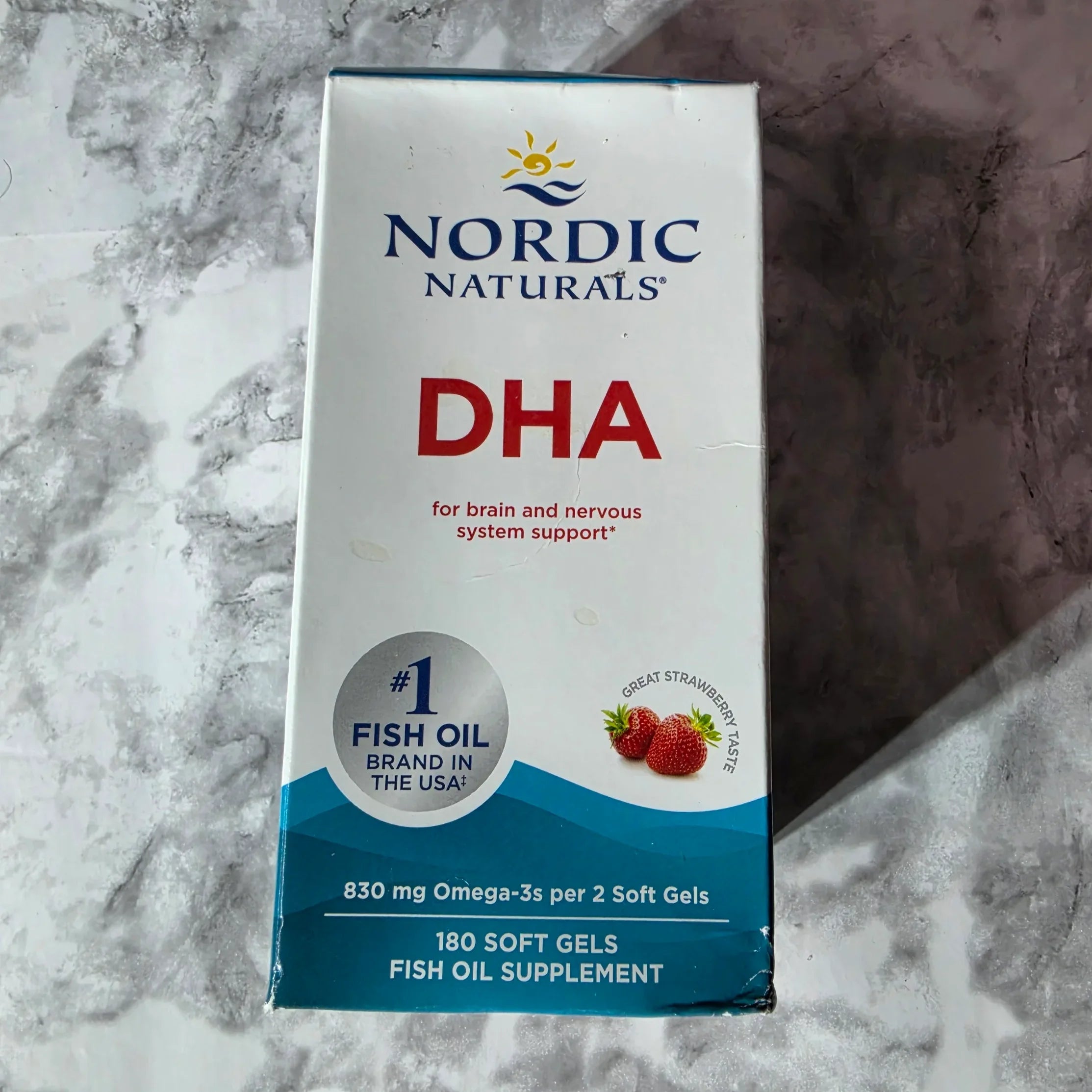 Nordic Naturals DHA supplement box on a marble surface