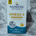 Box of Nordic Naturals Omega-3 fish oil supplement on a marble surface