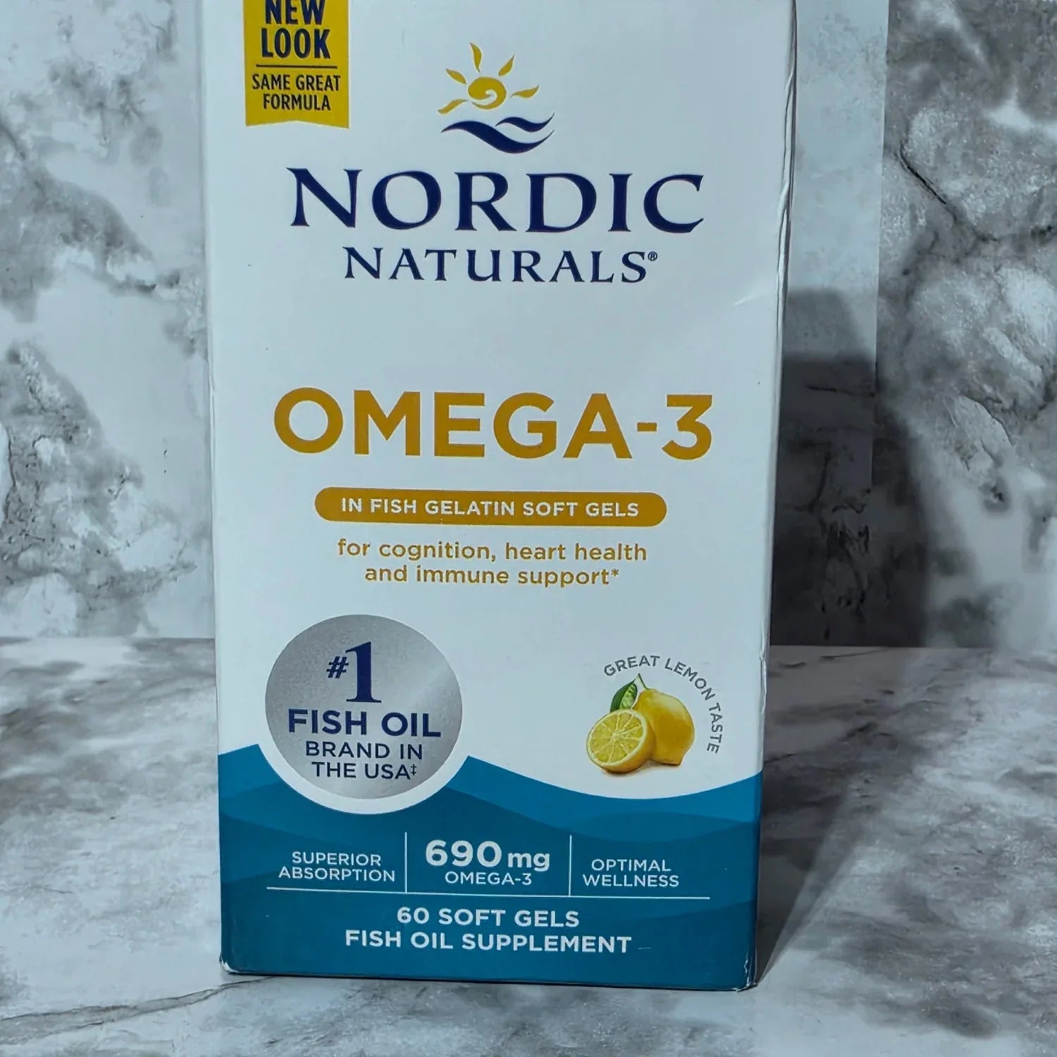 Box of Nordic Naturals Omega-3 fish oil supplement on a marble surface