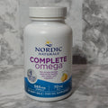 Nordic Naturals Complete Omega supplement bottle on a marble surface