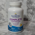 Nordic Naturals Complete Omega supplement bottle on a marble surface