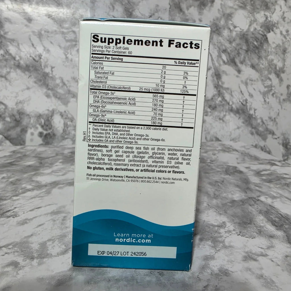 Supplement facts label on a box with a blue and white design, placed on a marble surface.