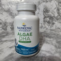 Nordic Naturals Algae DHA supplement bottle on a marble surface