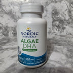 Nordic Naturals Algae DHA supplement bottle on a marble surface