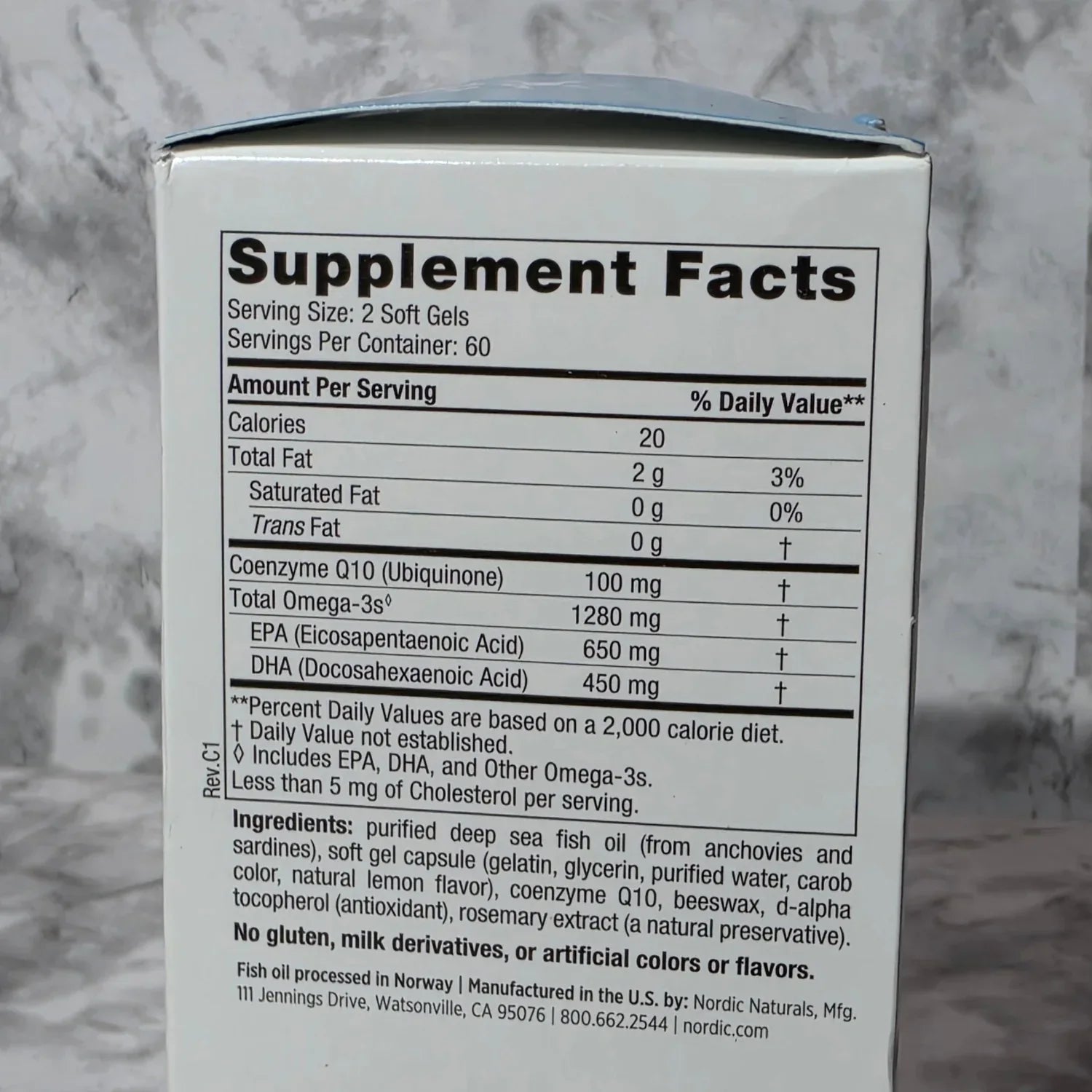 Supplement facts label on a box with a marble background
