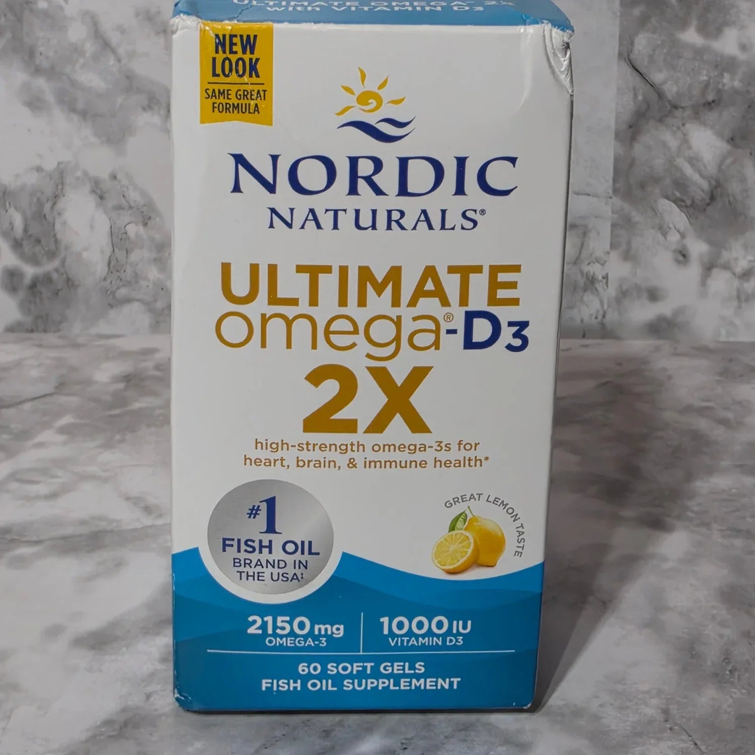 Nordic Naturals Ultimate Omega D3 2X supplement box on a marble surface