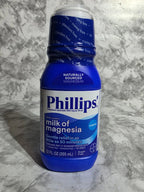 Phillips' Milk of Magnesia bottle on a marble surface