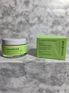 Cocokind skincare product and packaging on a gray marble background