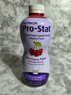 Bottle of Nutricia Pro-Stat Wild Cherry Punch on a marble surface