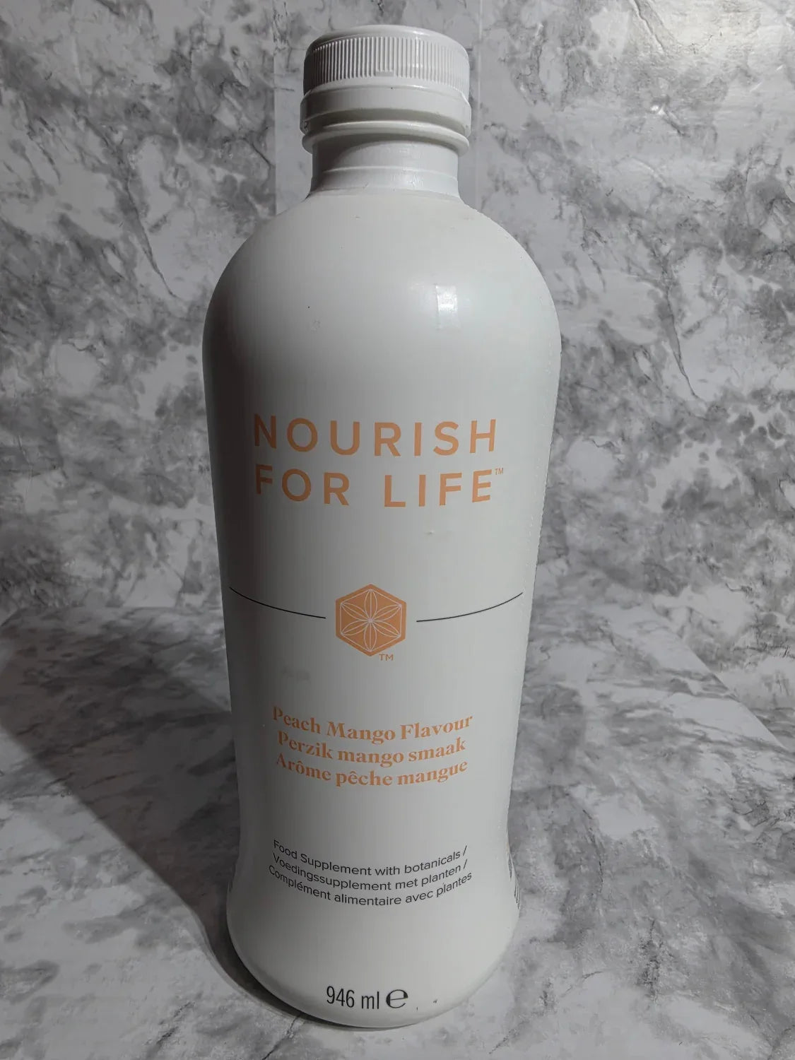 Bottle labeled 'Nourish for Life' on a gray marble surface