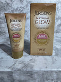 Jergens Natural Glow face moisturizer packaging on a marble surface