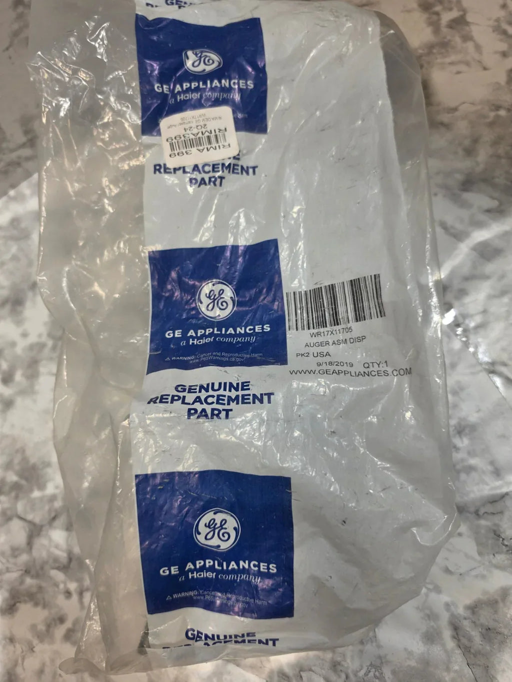 GE Appliances replacement part package on a marble countertop