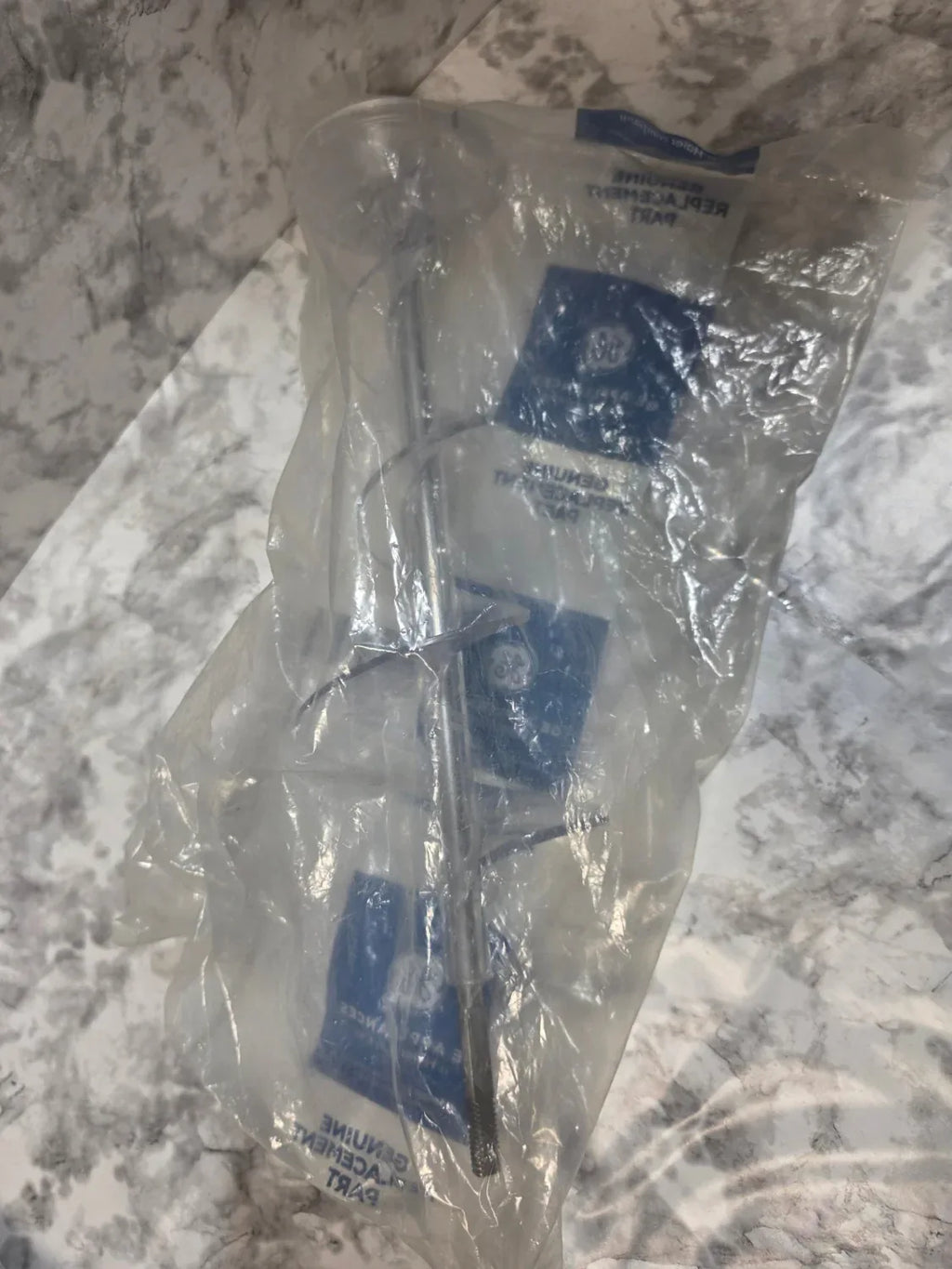 Clear plastic bag with a blue label on a marble surface