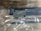 Metal switch component in a clear plastic package on a marble surface