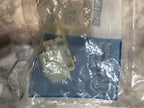 White plastic component in a clear plastic bag with Ford logo on a gray surface