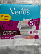 Gillette Venus razor packaging with Olay Comfortglide Sugarberry gel bar on a marble surface