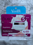 Olay Venus comfortglide sugarberry packaging on a marble surface