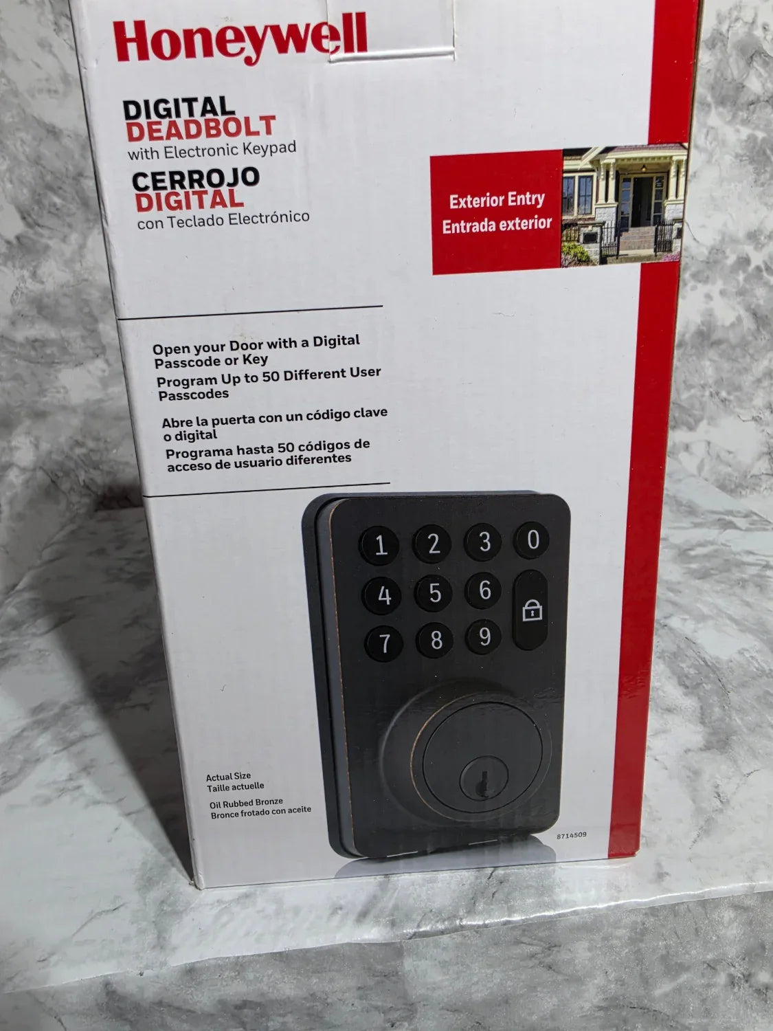 Honeywell digital deadbolt packaging on a marble surface