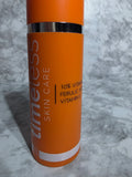 Orange skincare product tube with text on a gray marble background