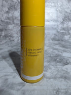 Yellow skincare product tube on a marble surface