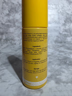 Yellow cylindrical container with text on a gray textured background