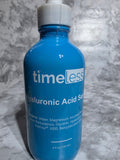 Blue bottle labeled 'timeless' on a gray marble surface