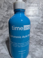 Blue bottle labeled 'timeless' on a gray marble surface