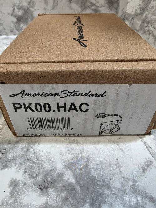 Cardboard box with American Standard branding on a marble surface