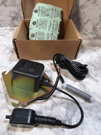 Electrical components including a power adapter and cable on a marble surface.